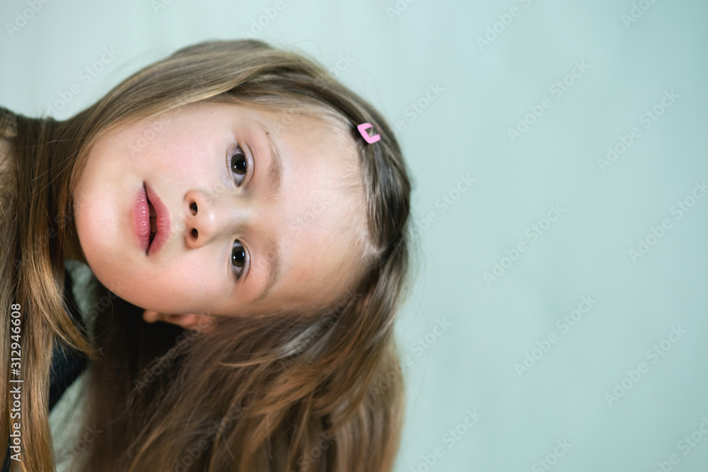 Close-up portrait of happy smiling little girl with long hair. Close-up portrait of happy smiling little girl with long hair.