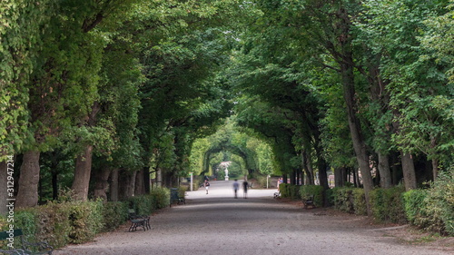 Bild auf Leinwand Tourists walking in park alley timelapse next to Schonbrunn Palace, imperial summer residence in Vienna, Austria