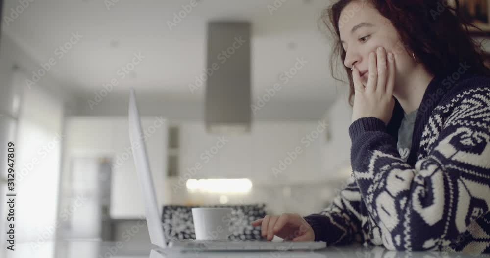 young woman starts to work on her laptop in the morning. dolly shot young woman starts to work on her laptop in the morning. dolly shot