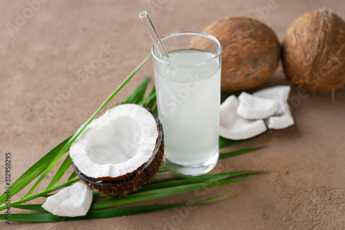 fresh coconuts and coconut water in glass with straw