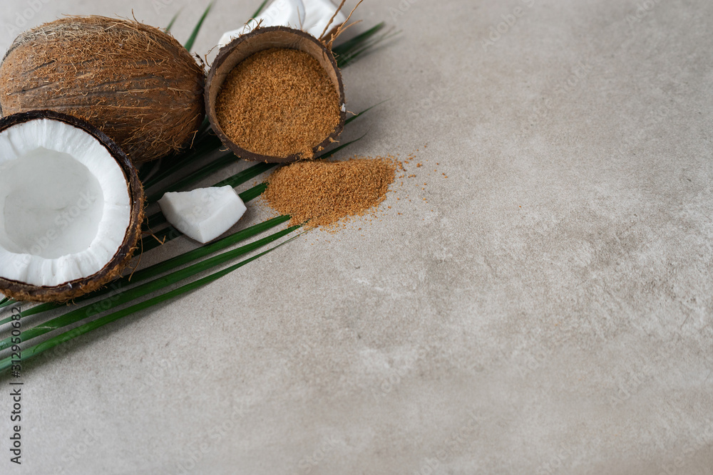 fresh coconuts with brown palm sugar on gray stone background