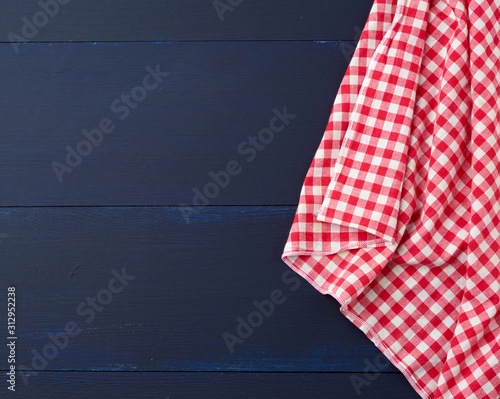 white red checkered kitchen towel on a blue wooden background