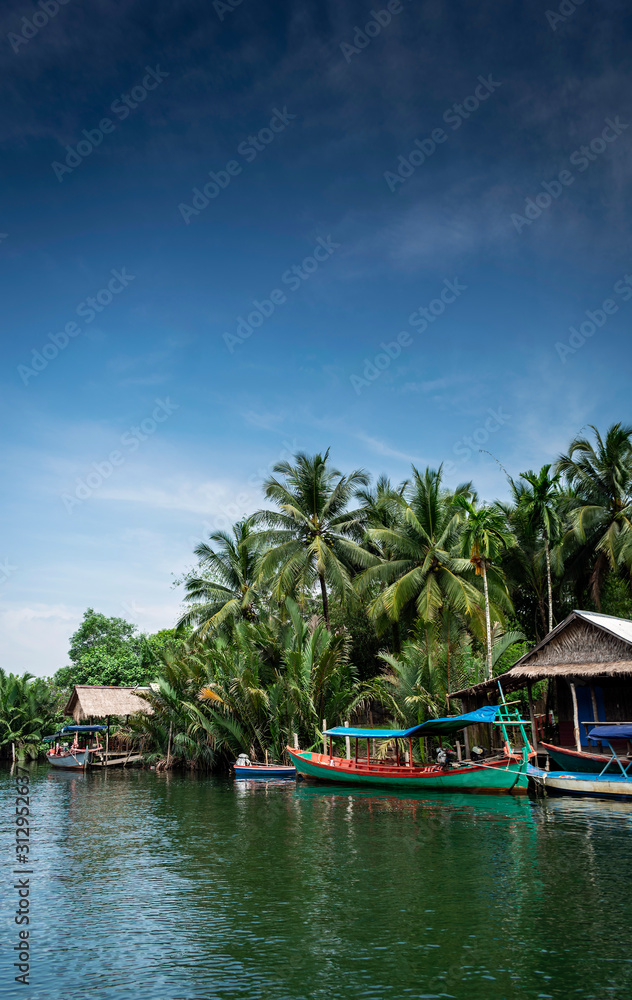 traditional jungle boat at pier on tatai river in cambodia