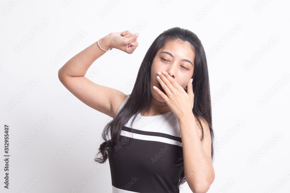 Sleepy young Asian woman yawn.