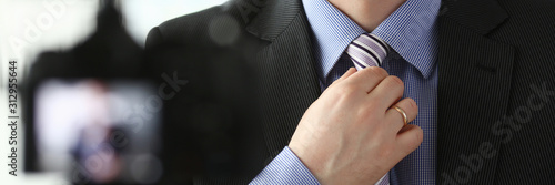 Male arm in blue suit set tie closeup on