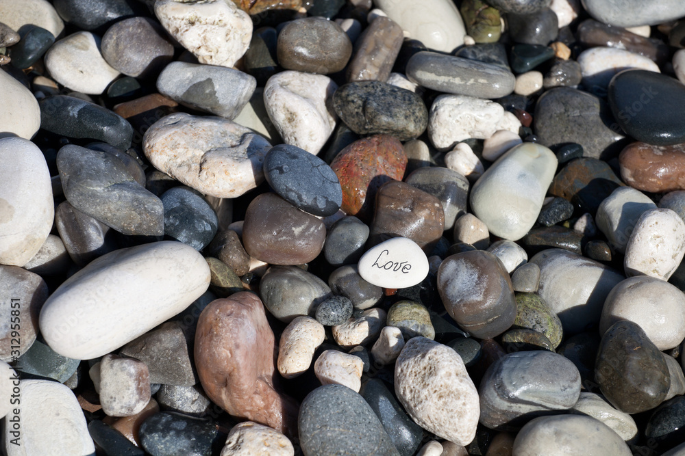 Words on pebble stones – motivational concept slogan – word love Words on pebble stones – motivational concept slogan – word love