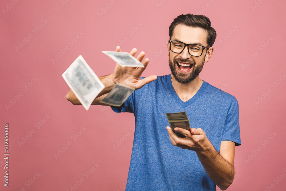 Portrait of a happy young businessman throwing out money banknotes isolated over pink background. Portrait of a happy young businessman throwing out money banknotes isolated over pink background.