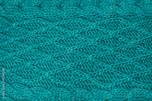 Texture knitting. Blue pullover. Pattern fabric made of wool. Background. Trending color in fashion design in the year 2020.