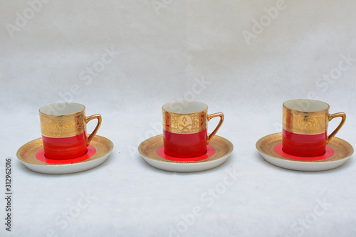 Mock up / design set of elegant and traditional colorful Red and gold traditional elegant coffee cup & Tea cup on cup's plate , template for branding identity and company logo design/ drink-ware