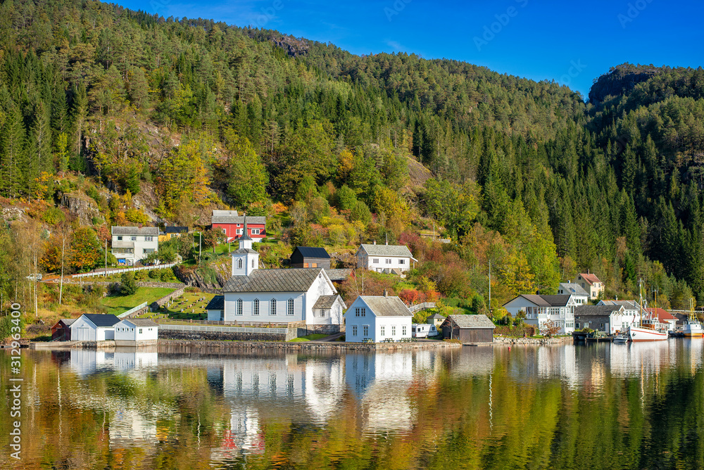 Beautiful water reflection of white Norwegian house in fjord , Norway