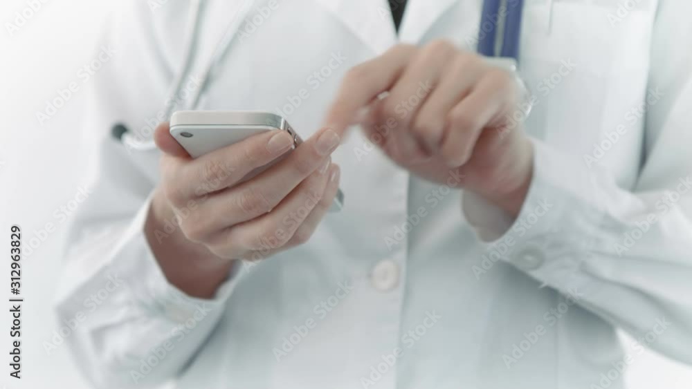 Female doctor using a mobile phone. Lateral dolly. More options in my portfolio. Female doctor using a mobile phone. Lateral dolly. More options in my portfolio.