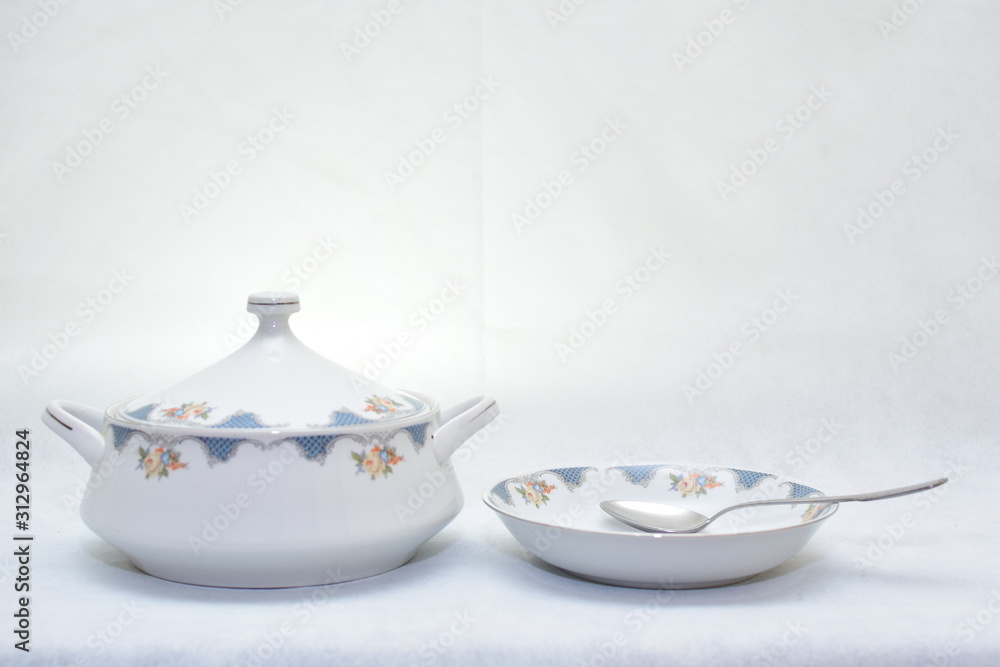 Mock up design set of elegant and traditional colorful white and blue dishware and dork knife spoon design dining ware and food plates and bowl isolated on white background Stock