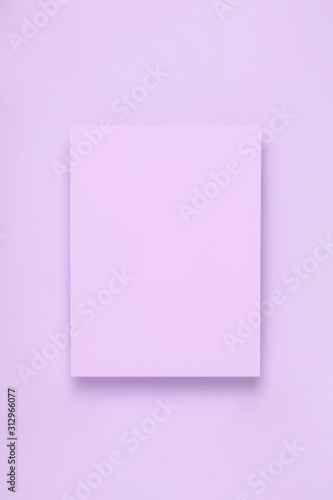 Minimal frame geometric composition mock up. Blank sheet of lilac paper postcard on delicate blue background. Template design invitation card. Top view, flat lay, copy space.