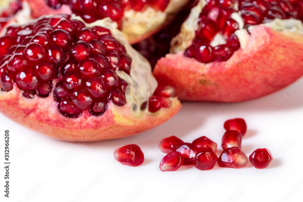 Ripe pomegranate fruit with seeds isolated on white Ripe pomegranate fruit with seeds isolated on white