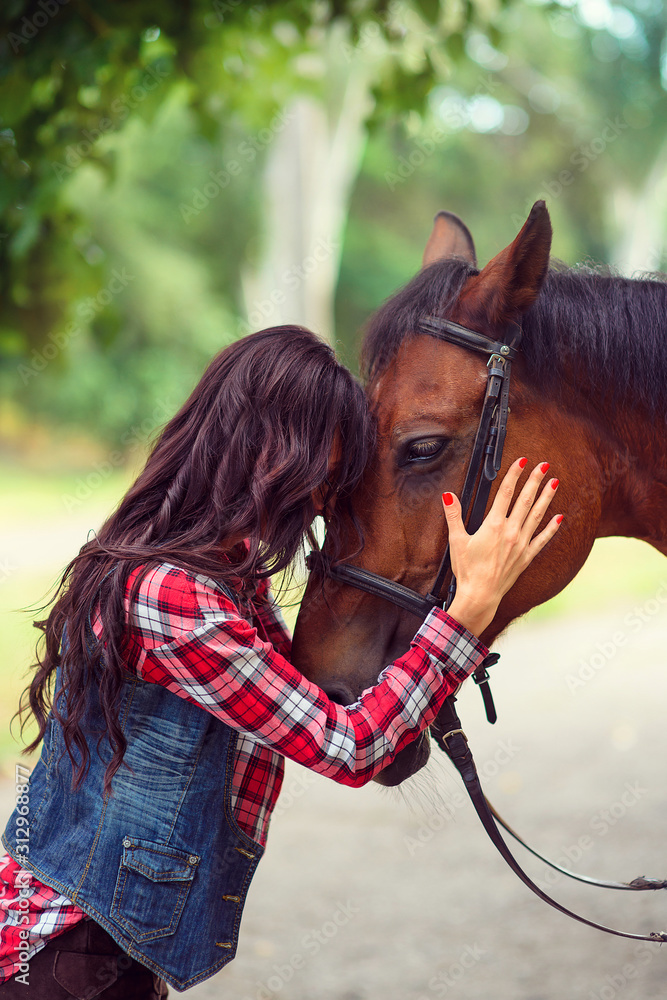 Obraz premium girl with long hair hugs horse