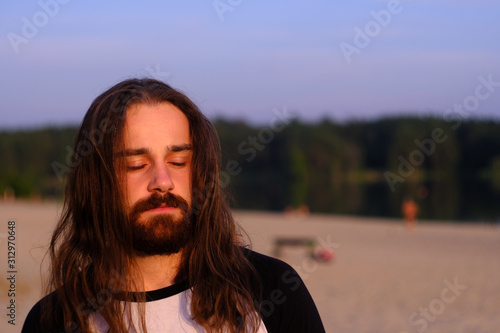 Photos Portrait of handsome bearded young man with long hair