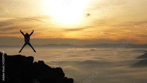 silhouette of man on the beach at sunset