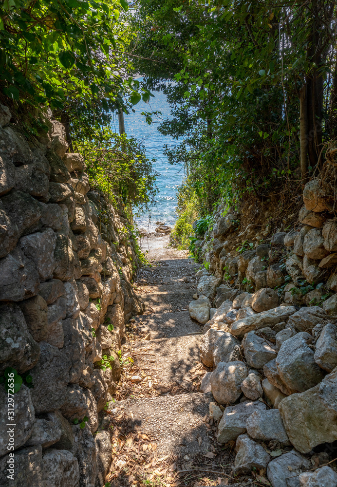 Stone stairs in a forest leading to the ocean. Mlini, Croatia. Stone stairs in a forest leading to the ocean. Mlini, Croatia.