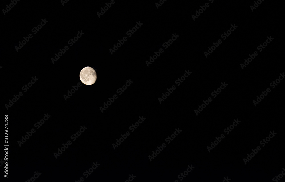 Full moon over dark black sky at night Full moon over dark black sky at night