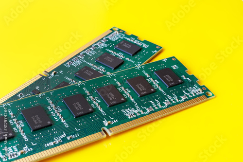 Two computer RAM modules on a yellow background. The concept of fast work technology, progress, acceleration. Selective focus. Is isolated.