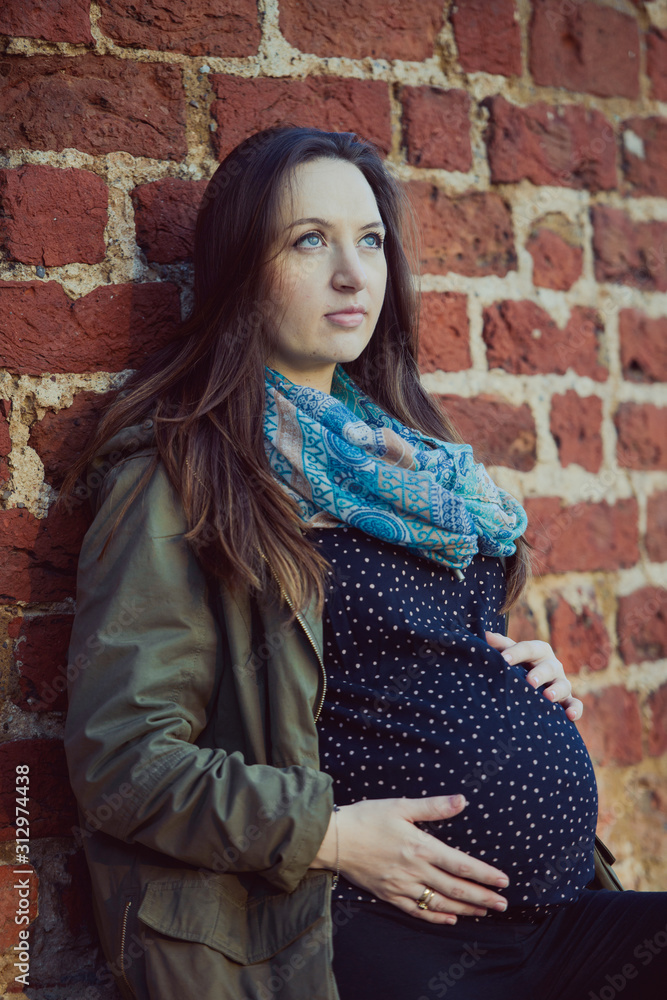 Pregnant woman relaxing on chair at desk in a room