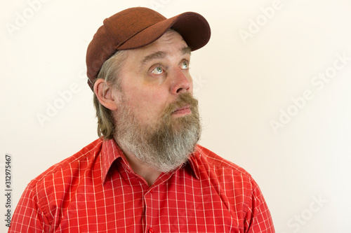 A brutal, bearded, stern man in a red shirt and baseball cap. A variety of emotions. Cruelty and masculinity.
