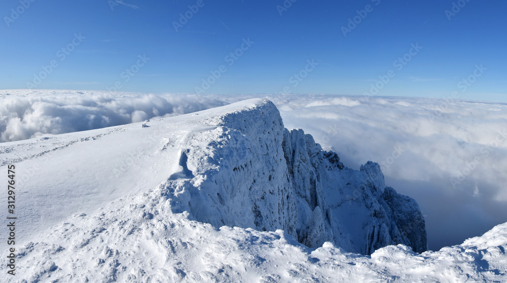 Winter mountains, Panoramic view of mountain peak above the clouds. Snowy landscape wallpaper