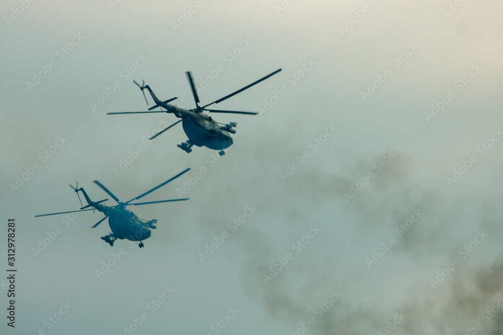 Fototapeta premium Military helicopter fired anti-armor missiles at sunset