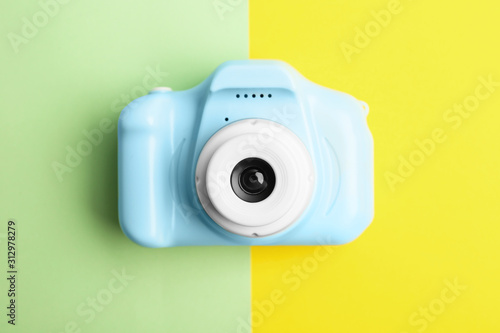 Light blue toy camera on color background, top view. Future photographer