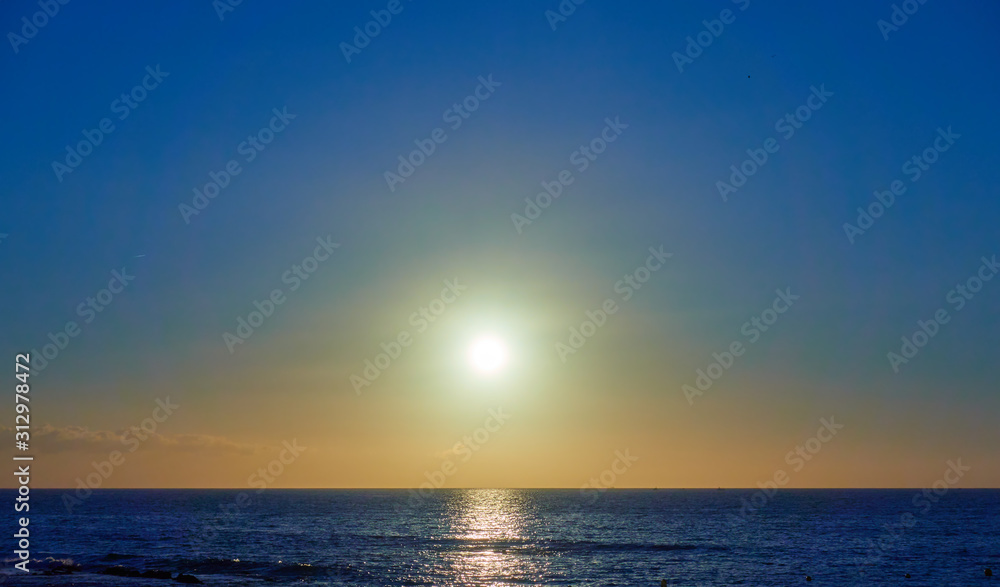 Atlantic ocean and the sun in cloudless sky