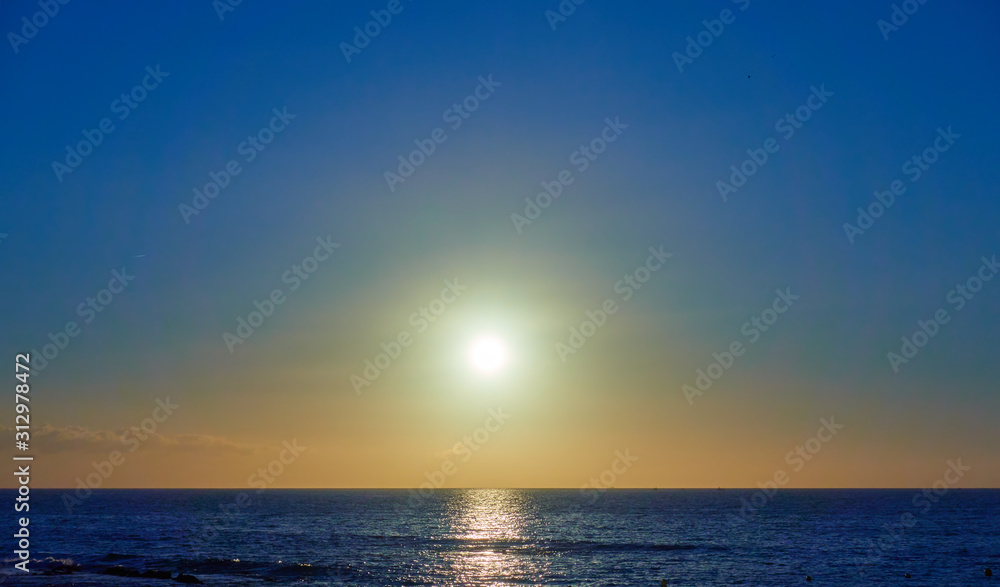 Atlantic ocean and the sun in cloudless sky Atlantic ocean and the sun in cloudless sky