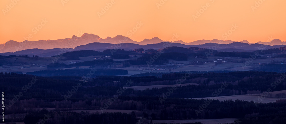 sunrise in mountains - landscape with mountains on horizon, clean yellow and orange sky
