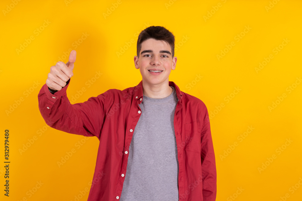 young teenager or student boy in casual style with positive gesture or greeting isolated on color background young teenager or student boy in casual style with positive gesture or greeting isolated on color background