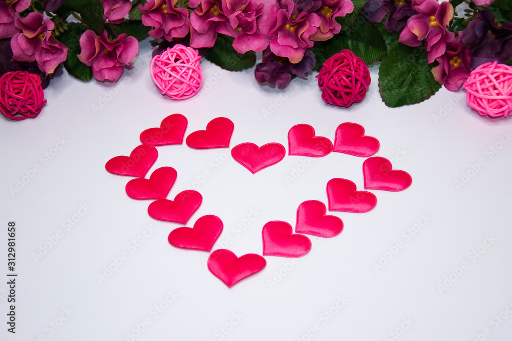 Heart made of hearts on a white background with copy space. Pink flowers. Valentine's Day