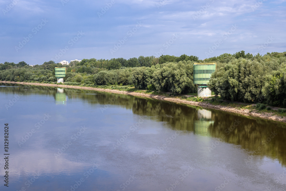 Bank of Vistula river with water treatment buildings seen from Siekierkowski Bridge in Warsaw, Poland