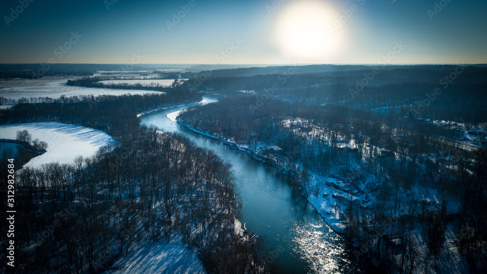 Aerial view of river meandering towards the sunset