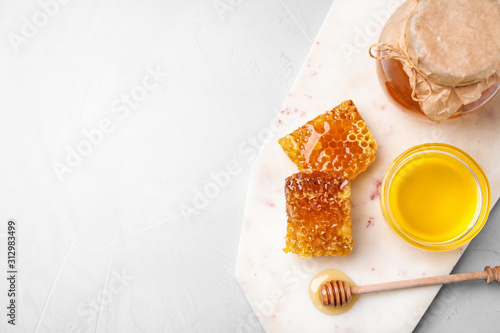 Tasty honey on light grey table, top view. Space for text photo