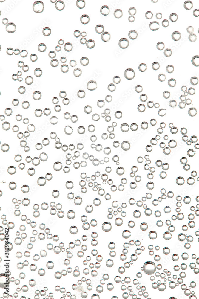 Water bubbles in a glass container on white background. close up