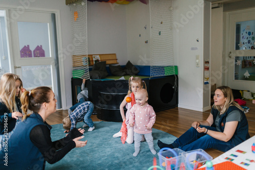 Teachers and children in playschool