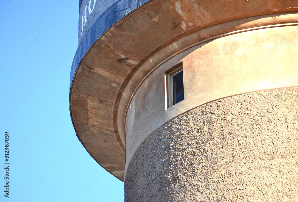Fototapeta premium Corner of a large concrete water tower in Mildura with a tiny window in it