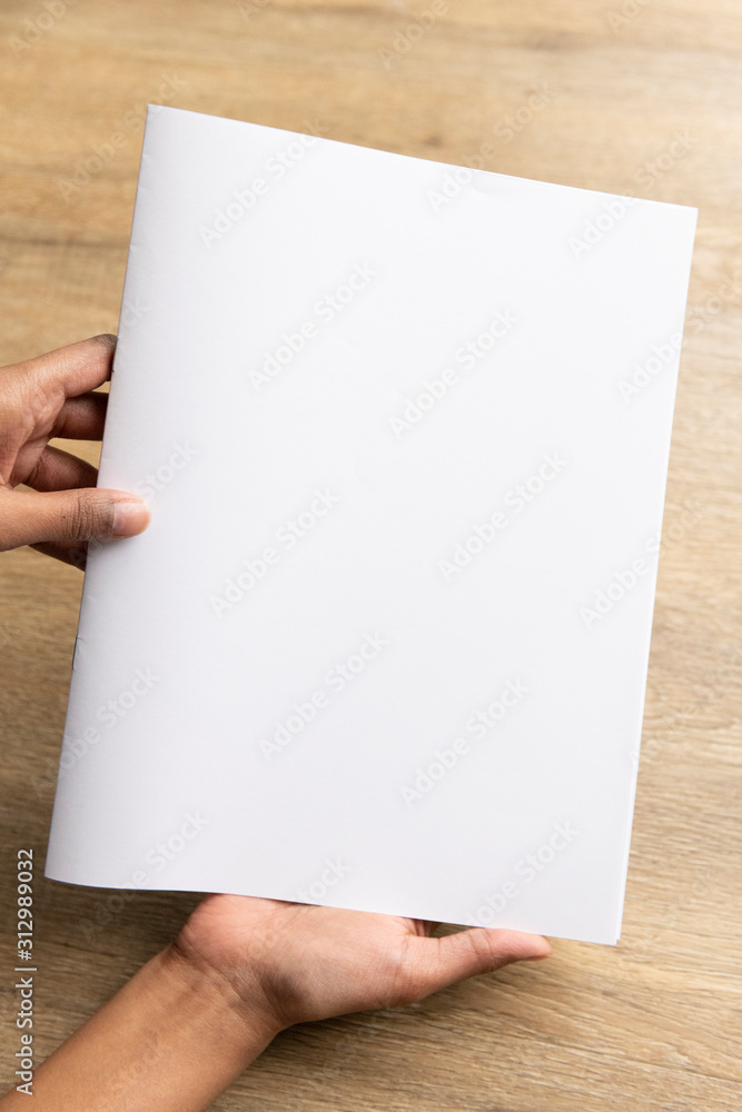 Ethnic model holding an A5 or half letter sized brochure Ethnic model holding an A5 or half letter sized brochure