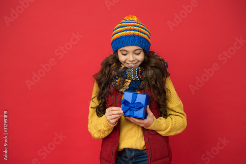 Shopping time. nice purchase. girl with new year present box. happy winter holidays. little girl knitted hat and scarf. merry christmas. xmas party mood. winter shopping sales. childhood happiness