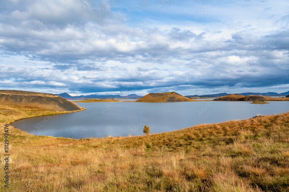 The lake of Myvatn is surrounded by mountains with a beautiful sky