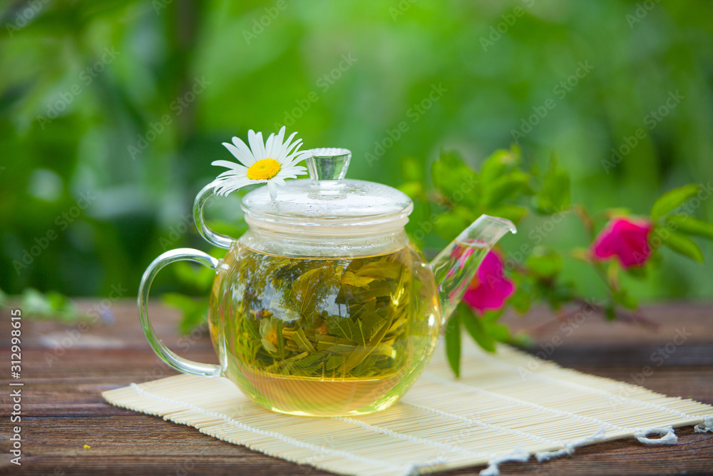 green tea with chamomile in cup green tea with chamomile in cup