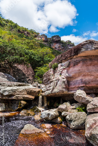 Little waterfall formed by water crossing rocky landscape in natural park in Brazil
