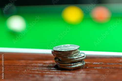 50p pieces on pool table photo