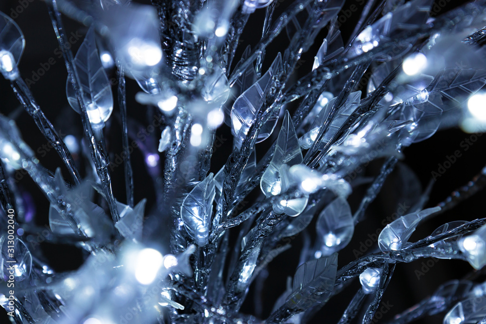 Close up detail of a Christmas tree decorated with iridescent lights Close up detail of a Christmas tree decorated with iridescent lights