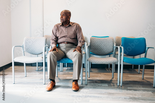 Mature man waiting in medical office photo