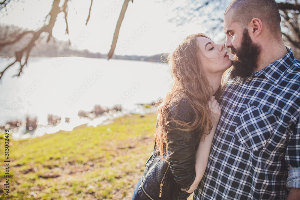 A girl and a guy are walking in the park. Portrait of a couple, a love story.Happy smiling, loving couple together outstretched at beautiful nature. A girl and a guy are walking in the park. Portrait of a couple, a love story.Happy smiling, loving couple together outstretched at beautiful nature.
