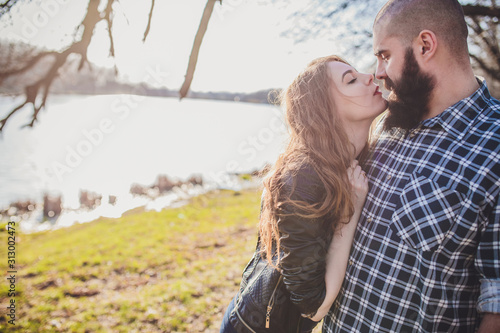 A girl and a guy are walking in the park. Portrait of a couple, a love story.Happy smiling, loving couple together outstretched at beautiful nature.